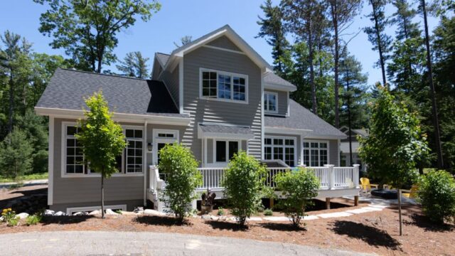 Woodstone custom home in Glen Arbor, Michigan with Ply Gem Mastic siding in Victorian Grey and Azek decking in Island Oak